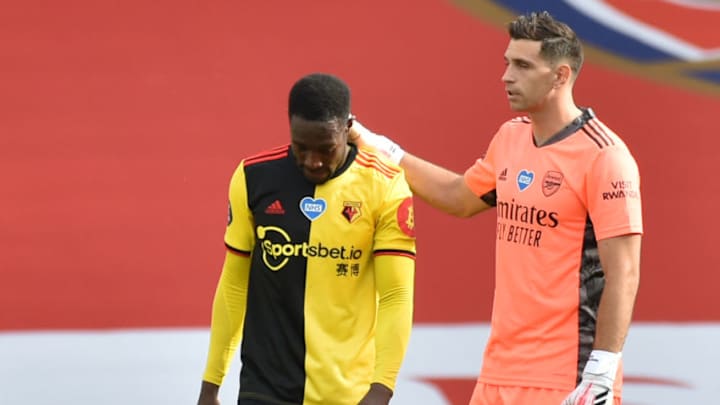 Watford's English striker Danny Welbeck (L) is consoled by Arsenal's Argentinian goalkeeper Emiliano Martinez after losing the English Premier League football match between Arsenal and Watford at the Emirates Stadium in London on July 26, 2020. (Photo by Rui Vieira / POOL / AFP) / RESTRICTED TO EDITORIAL USE. No use with unauthorized audio, video, data, fixture lists, club/league logos or 'live' services. Online in-match use limited to 120 images. An additional 40 images may be used in extra time. No video emulation. Social media in-match use limited to 120 images. An additional 40 images may be used in extra time. No use in betting publications, games or single club/league/player publications. / (Photo by RUI VIEIRA/POOL/AFP via Getty Images)