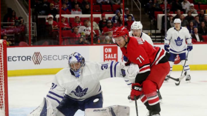 RALEIGH, NC – DECEMBER 11: Lucas Wallmark #71 of the Carolina Hurricanes skates near the crease as Frederik Andersen #31 of the Toronto Maple Leafs extencs his glove hand to interfere near the crease during an NHL game on December 11, 2018 at PNC Arena in Raleigh, North Carolina. (Photo by Gregg Forwerck/NHLI via Getty Images)