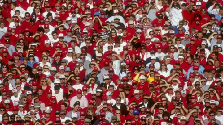 27 Nov 1998: Fans for the Nebraska Cornhuskers crowd the stadium dressed in red and white during a game against the Colorado Buffalos at Memorial Stadium in Lincoln, Nebraska. Nebraska defeated Colorado 16-14. Mandatory Credit: Matthew Stockman /Allsport
