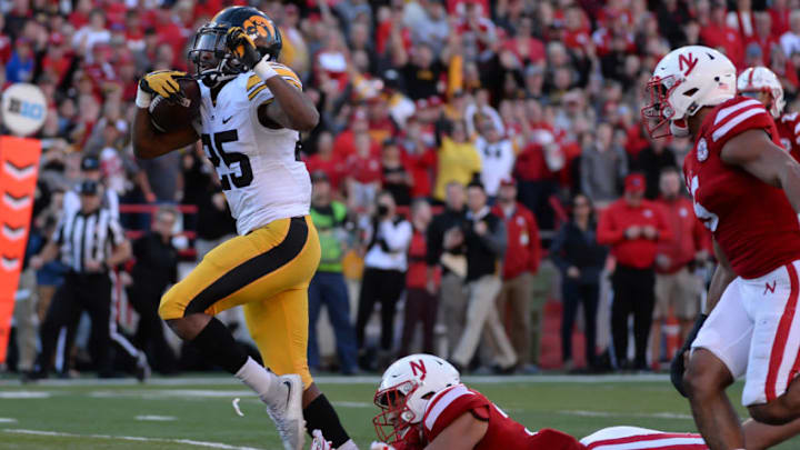 LINCOLN, NE - NOVEMBER 24: Running back Akrum Wadley #25 of the Iowa Hawkeyes avoids the tackle of linebacker Collin Miller #31 of the Nebraska Cornhuskers to score at Memorial Stadium on November 24, 2017 in Lincoln, Nebraska. (Photo by Steven Branscombe/Getty Images)