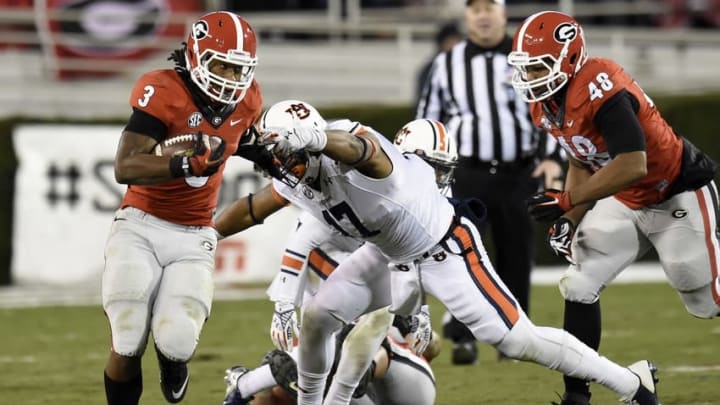 Nov 15, 2014; Athens, GA, USA; Georgia Bulldogs running back Todd Gurley (3) breaks a tackle by Auburn Tigers linebacker Kris Frost (17) during the second half at Sanford Stadium. Georgia defeated Auburn 34-7. Mandatory Credit: Dale Zanine-USA TODAY Sports