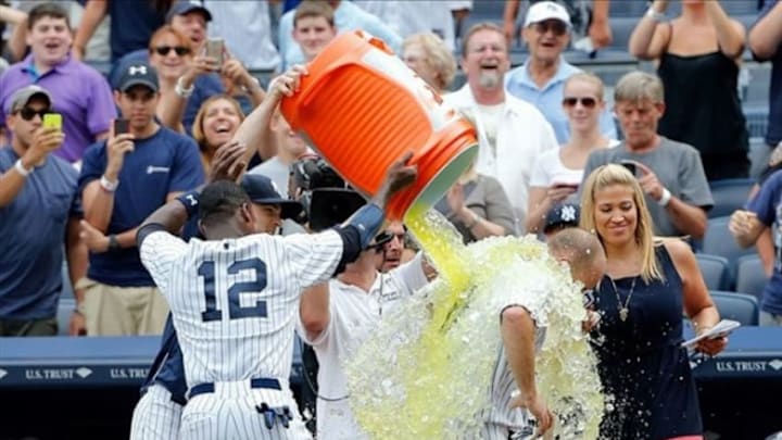 Aug 11, 2013; Bronx, NY, USA; New York Yankees center fielder Brett Gardner (11) is dunked with Gatorade by teammates including Alfonso Soriano (12) after hitting a walk off home run against the Detroit Tigers at Yankee Stadium. Yankees won 5-4. Mandatory Credit: Anthony Gruppuso-USA TODAY Sports