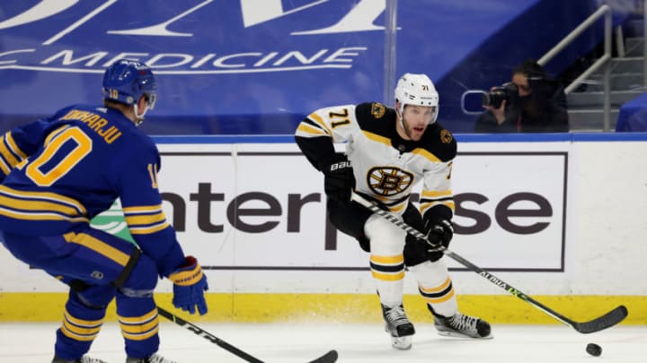 Apr 22, 2021; Buffalo, New York, USA; Buffalo Sabres defenseman Henri Jokiharju (10) looks to block a pass by Boston Bruins left wing Taylor Hall (71) during the third period at KeyBank Center. Mandatory Credit: Timothy T. Ludwig-USA TODAY Sports