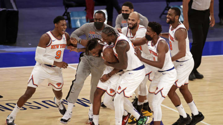 Mar 18, 2021; New York, New York, USA; New York Knicks forward Reggie Bullock is mobbed by teammates after taking the ball away from the Orlando Magic in the final seconds of the second half of an NBA basketball game Thursday, March 18, 2021, in New York. The Knicks won 94-93. Mandatory Credit: Adam Hunger/Pool Photo-USA TODAY Sports
