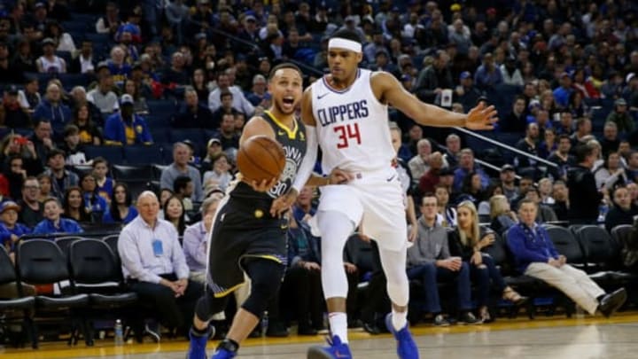 OAKLAND, CA – FEBRUARY 22: Stephen Curry #30 of the Golden State Warriors is defended by Tobias Harris #34 of the Los Angeles Clippers at ORACLE Arena on February 22, 2018 in Oakland, California. NOTE TO USER: User expressly acknowledges and agrees that, by downloading and or using this photograph, User is consenting to the terms and conditions of the Getty Images License Agreement. (Photo by Lachlan Cunningham/Getty Images)