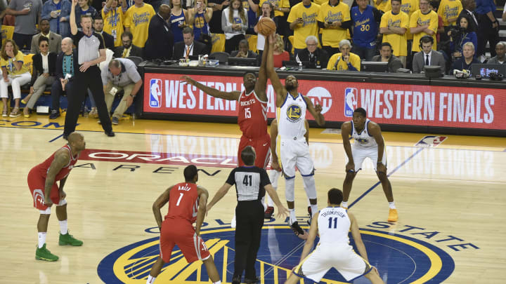 OAKLAND, CA – MAY 26: Clint Capela #15 of the Houston Rockets and Kevin Durant #35 of the Golden State Warriors tipoff for Game Six of the Western Conference Finals during the 2018 NBA Playoffs on May 26, 2018 at ORACLE Arena in Oakland, California. NOTE TO USER: User expressly acknowledges and agrees that, by downloading and/or using this Photograph, user is consenting to the terms and conditions of the Getty Images License Agreement. Mandatory Copyright Notice: Copyright 2018 NBAE (Photo by Bill Baptist/NBAE via Getty Images)
