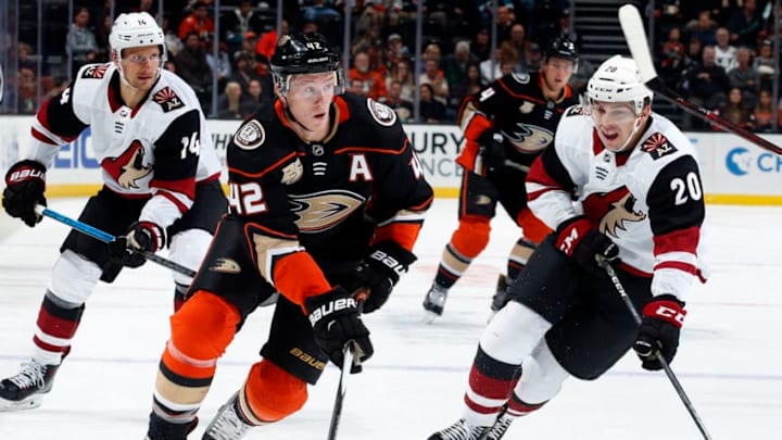 ANAHEIM, CA - OCTOBER 10: Josh Manson #42 of the Anaheim Ducks skates with the puck against Dylan Strome #20 and Richard Panik #14 of the Arizona Coyotes during the game on October 10, 2018 at Honda Center in Anaheim, California. (Photo by Debora Robinson/NHLI via Getty Images)