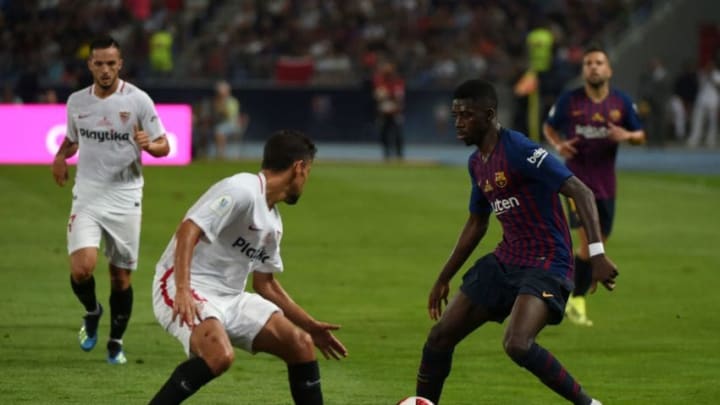 Sevilla's Spanish midfielder Jesus Navas (L) vies with Barcelona's French forward Ousmane Dembele during the Spanish Super Cup final between Sevilla and FC Barcelona at Ibn Batouta stadium in the Moroccan city of Tangiers on August 12, 2018. (Photo by FADEL SENNA / AFP) (Photo credit should read FADEL SENNA/AFP/Getty Images)