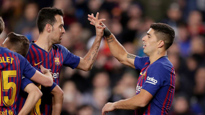 Barcelona's Sergio Busquets and Luis Suarez celebrate goal during the match against Sevilla. (Photo by Jeroen Meuwsen/Soccrates/Getty Images)