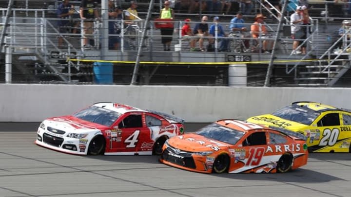 Jun 14, 2015; Brooklyn, MI, USA; Sprint Cup Series driver Kevin Harvick (4) races Sprint Cup Series driver Carl Edwards (19) and Sprint Cup Series driver Matt Kenseth (20) during the Quicken Loans 400 at Michigan International Speedway. Mandatory Credit: Aaron Doster-USA TODAY Sports
