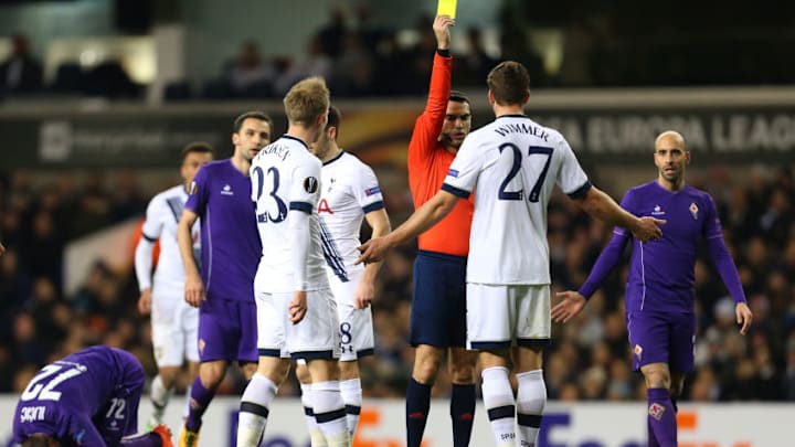 LONDON, ENGLAND - FEBRUARY 25 : Kevin Wimmer of Tottenham Hotspur is shown a yellow card by referee Ovidiu Hategan during the UEFA Europa League match between Tottenham Hotspur and Fiorentina at White Hart Lane on February 25, 2016 in London, United Kingdom. (Photo by Catherine Ivill - AMA/Getty Images)