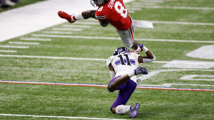 INDIANAPOLIS, IN – DECEMBER 19: Trey Sermon #8 of the Ohio State Buckeyes gets upended by A.J. Hampton #11 of the Northwestern Wildcats in the first quarter of the Big Ten Championship at Lucas Oil Stadium on December 19, 2020 in Indianapolis, Indiana. (Photo by Joe Robbins/Getty Images)