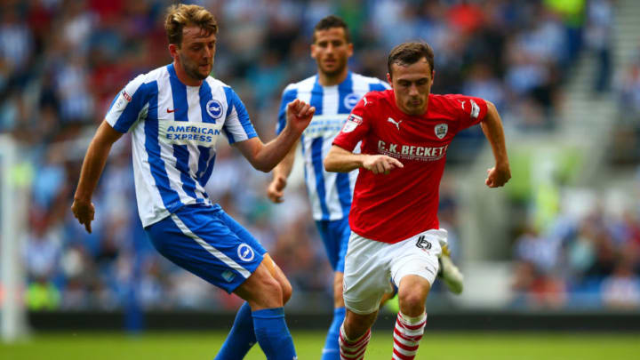 BRIGHTON, ENGLAND - SEPTEMBER 24: Josh Scowen of Barnsley battles for the ball with Dale Stephens of Brighton