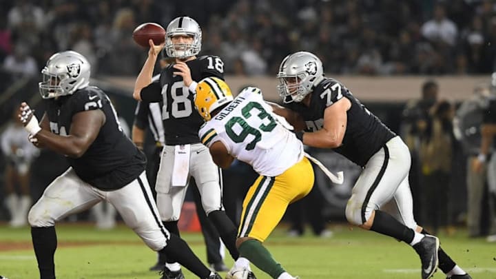 OAKLAND, CA - AUGUST 24: Connor Cook #18 of the Oakland Raiders looks to pass against the Green Bay Packers during the second quarter of an NFL preseason football game at Oakland-Alameda County Coliseum on August 24, 2018 in Oakland, California. (Photo by Thearon W. Henderson/Getty Images)