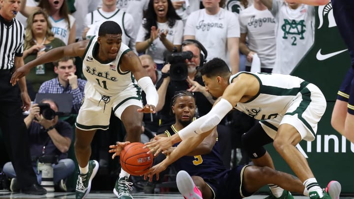 EAST LANSING, MI – MARCH 09: Zavier Simpson #3 of the Michigan Wolverines looks to pass the ball between the defense of Aaron Henry #11 and Kenny Goins #25 of the Michigan State Spartans during the first half at Breslin Center on March 9, 2019 in East Lansing, Michigan. (Photo by Gregory Shamus/Getty Images)