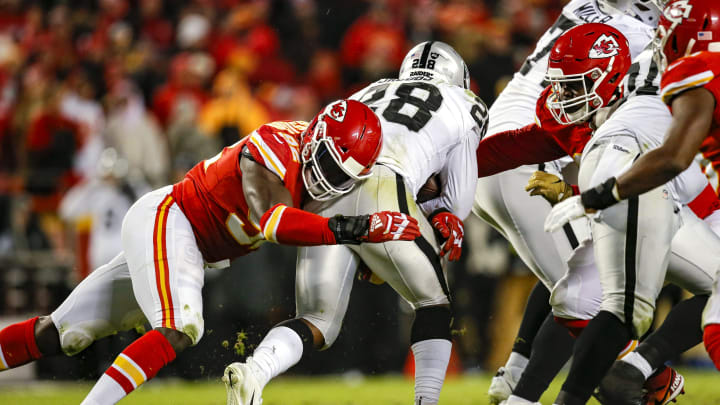 Tanoh Kpassagnon #92 of the Kansas City Chiefs tackles Josh Jacobs #28 of the Oakland Raiders (Photo by David Eulitt/Getty Images)