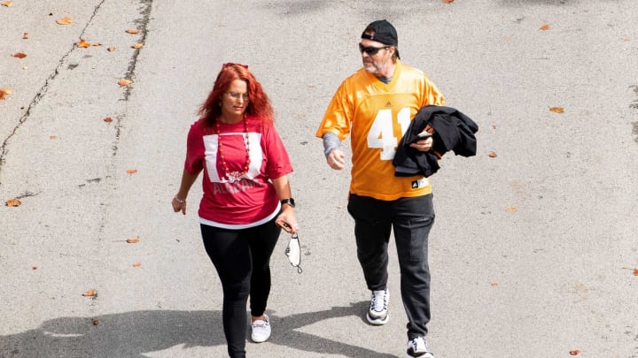 An Alabama and a Tennessee fan walk around Neyland Stadium before Tennessee’s SEC conference game against Alabama on Saturday, October 24, 2020.Kns Ut Bama Fans Bp
