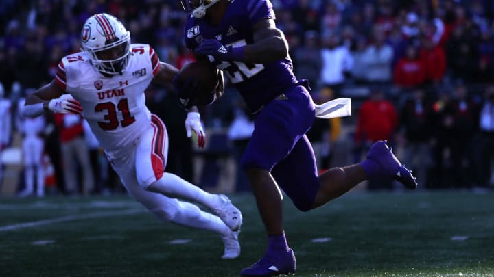 SEATTLE, WASHINGTON – NOVEMBER 02: Salvon Ahmed #26 of the Washington Huskies runs with the ball in the third quarter against JaTravis Broughton #31 of the Utah Utes during their game at Husky Stadium on November 02, 2019 in Seattle, Washington. (Photo by Abbie Parr/Getty Images)