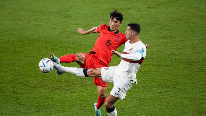 AL RAYYAN, QATAR - DECEMBER 02: Inbeom Hwang of Korea (L) battles for the ball with Cristiano Ronaldo of Portugal (R) during the FIFA World Cup Qatar 2022 Group H match between Korea Republic and Portugal at Education City Stadium on December 2, 2022 in Al Rayyan, Qatar. (Photo by Geovaine Oliveira/Eurasia Sport Images/Getty Images)