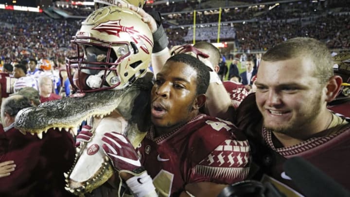 TALLAHASSEE, FL - NOVEMBER 26: DeMarcus Walker #44 of the Florida State Seminoles carries a gator head wearing his helmet as he celebrates after the game against the Florida Gators at Doak Campbell Stadium on November 26, 2016 in Tallahassee, Florida. Florida State defeated Florida 31-13. (Photo by Joe Robbins/Getty Images)