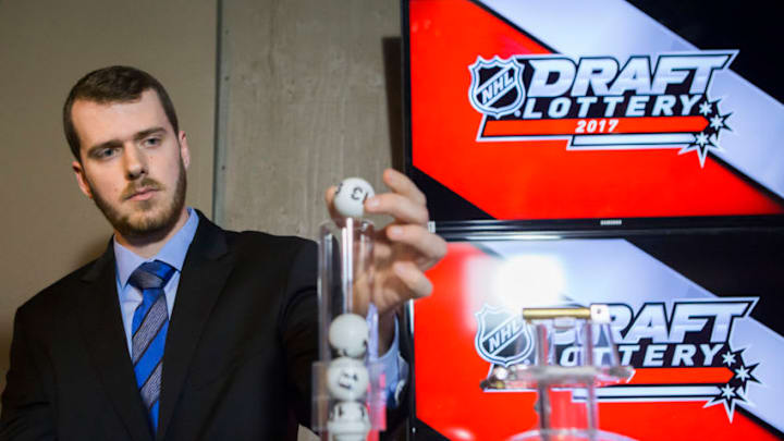 TORONTO, ON - APRIL 29: NHL official loads the lottery ball machine during the NHL Draft Lottery at the CBC Studios in Toronto, Ontario, Canada on April 29, 2017. (Photo by Kevin Sousa/NHLI via Getty Images)