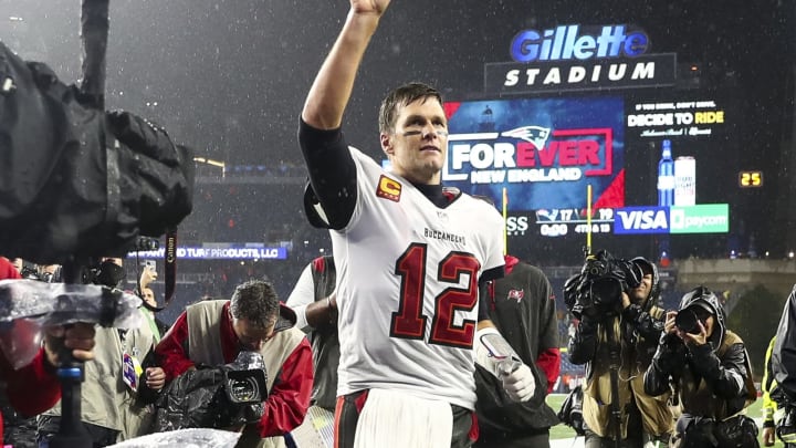 FOXBOROUGH, MASSACHUSETTS – OCTOBER 03: Tom Brady #12 of the Tampa Bay Buccaneers waves to the crowd as he runs off the field after defeating the New England Patriots in the game at Gillette Stadium on October 03, 2021 in Foxborough, Massachusetts. (Photo by Adam Glanzman/Getty Images)