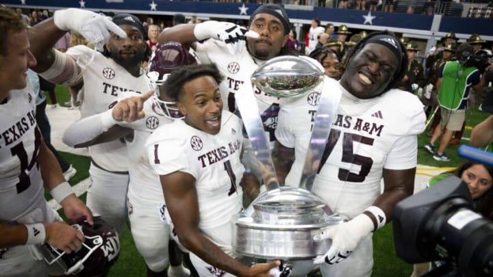 Sep 30, 2023; Arlington, Texas, USA; DUPLICATE***Texas A&M Aggies wide receiver Evan Stewart (1) and offensive lineman Kam Dewberry (75) celebrate with the Southwest Classic trophy after the Aggies victory over the Arkansas Razorbacks at AT&T Stadium. Mandatory Credit: Jerome Miron-USA TODAY Sports