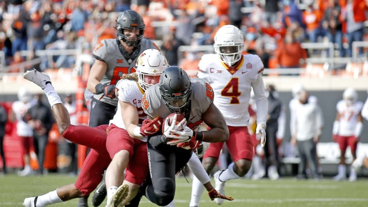 Oct 24, 2020; Stillwater, Oklahoma, USA; Oklahoma State Cowboys player Jelani Woods (89) scores a touchdown as Iowa State Cyclones player Mike Rose defends in the first quarter at Boone Pickens Stadium. Mandatory Credit: Sarah Phipps-USA TODAY Sports