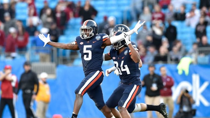 CHARLOTTE, NORTH CAROLINA - DECEMBER 29: Tim Harris #5 of the Virginia Cavaliers reacts after intercepting a pass against the South Carolina Gamecocks during the Belk Bowl at Bank of America Stadium on December 29, 2018 in Charlotte, North Carolina. Virginia won 28-0. (Photo by Grant Halverson/Getty Images)