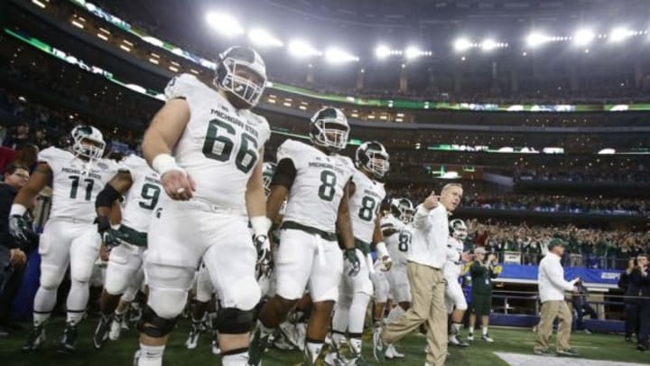Dec 31, 2015; Arlington, TX, USA; Michigan State Spartans head coach Mark Dantonio leads his team to the field before the 2015 CFP semifinal at the Cotton Bowl against the Alabama Crimson Tide at AT&T Stadium. Mandatory Credit: Tim Heitman-USA TODAY Sports