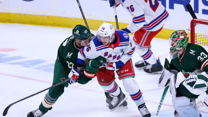 Mar 8, 2022; Saint Paul, Minnesota, USA; Minnesota Wild center Nick Bjugstad (27) hits New York Rangers center Jonny Brodzinski (76) during the third period at Xcel Energy Center. Mandatory Credit: Harrison Barden-USA TODAY Sports