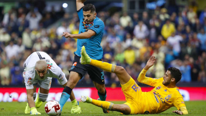Nahuel Guzmán (left) and defender Diego Reyes (right) will have their hands full against América's Henry Martín (center), the top scorer in Liga MX this season. (Photo by Agustin Cuevas/Getty Images)