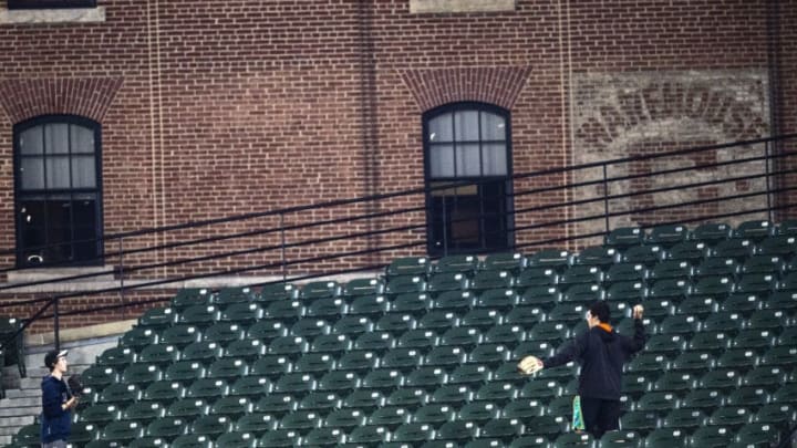 BALTIMORE, MD - MAY 8: Fans play catch in the stands during a game between the Boston Red Sox and the Baltimore Orioles on May 8, 2019 at Oriole Park at Camden Yards in Baltimore, Maryland. (Photo by Billie Weiss/Boston Red Sox/Getty Images)
