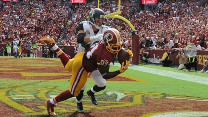Sep 14, 2014; Landover, MD, USA; Washington Redskins tight end Niles Paul (84) chatches a touchdown as Jacksonville Jaguars strong safety Chris Prosinski (42) defends during the second half at FedEx Field. Mandatory Credit: Brad Mills-USA TODAY Sports