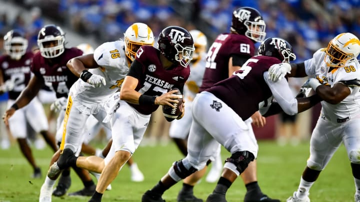 Sep 4, 2021; College Station, Texas, USA; Texas A&M Aggies quarterback Haynes King (13) runs the ball under pressure from Kent State Golden Flashes linebacker Matt Harmon (15) during the first quarter at Kyle Field. Mandatory Credit: Maria Lysaker-USA TODAY Sports