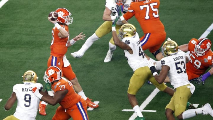 ARLINGTON, TEXAS - DECEMBER 29: Trevor Lawrence #16 of the Clemson Tigers looks to pass in the first half against Julian Okwara #42 of the Notre Dame Fighting Irish during the College Football Playoff Semifinal Goodyear Cotton Bowl Classic at AT&T Stadium on December 29, 2018 in Arlington, Texas. (Photo by Tim Warner/Getty Images)