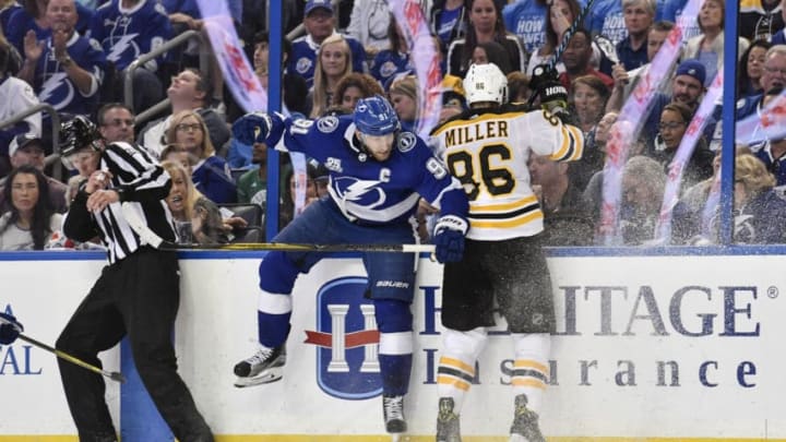 TAMPA, FL - APRIL 30: Tampa Bay Lightning center Steven Stamkos (91) finishes his check on Boston Bruins defender Kevan Miller (86) during the second period of an NHL Stanley Cup Eastern Conference Playoffs game between the Boston Bruins and the Tampa Bay Lightning on April 30, 2018, at Amalie Arena in Tampa, FL. (Photo by Roy K. Miller/Icon Sportswire via Getty Images)