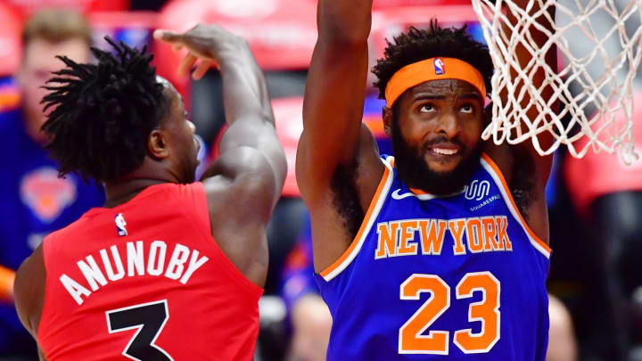 TAMPA, FLORIDA – DECEMBER 31: Mitchell Robinson #23 of the New York Knicks looks to dunk against OG Anunoby #3 of the Toronto Raptors. Both are possible Minnesota Timberwolves targets. (Photo by Julio Aguilar/Getty Images)