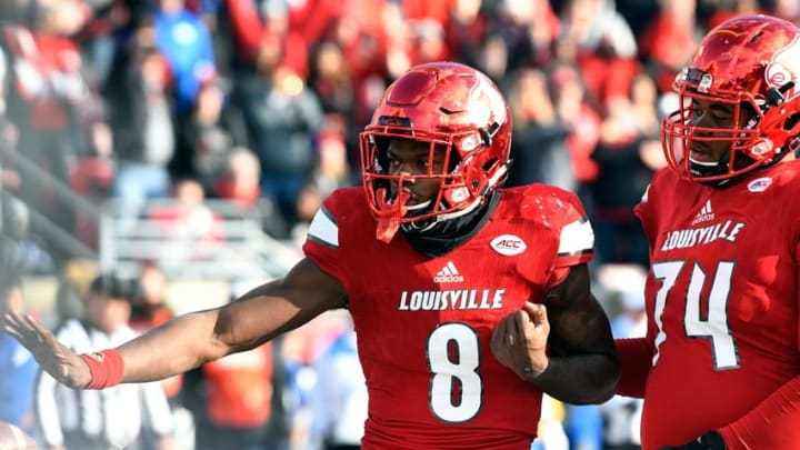 Nov 26, 2016; Louisville, KY, USA; Louisville Cardinals quarterback Lamar Jackson (8) strikes a pose after scoring a touchdown against the Kentucky Wildcats during the second half at Papa John