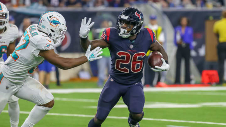 HOUSTON, TX - OCTOBER 25: Houston Texans running back Lamar Miller (26) evades a tackle by Miami Dolphins linebacker Raekwon McMillan (52) during the football game between the Miami Dolphins and Houston Texans on October 25, 2018 at NRG Stadium in Houston, Texas. (Photo by Leslie Plaza Johnson/Icon Sportswire via Getty Images)