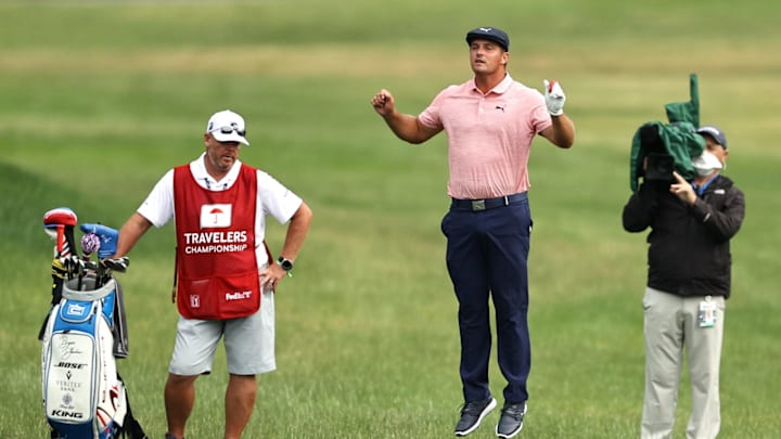 CROMWELL, CONNECTICUT – JUNE 28: Bryson DeChambeau of the United States jumps after playing his shot on the 18th hole during the final round of the Travelers Championship at TPC River Highlands on June 28, 2020 in Cromwell, Connecticut. (Photo by Elsa/Getty Images)