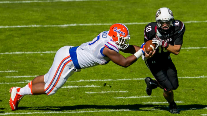 Nov 14, 2015; Columbia, SC, USA; South Carolina Gamecocks quarterback Perry Orth (10) scrambles past Florida Gators defensive lineman Caleb Brantley (57) in the first half at Williams-Brice Stadium. Mandatory Credit: Jeff Blake-USA TODAY Sports