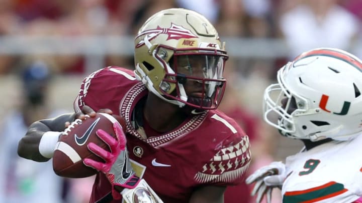 TALLAHASSEE OCTOBER 7: Quarterback James Blackman #1 of the Florida State Seminoles scrambles away from defensive lineman Chad Thomas #9 of the Miami Hurricanes during the second half of an NCAA football game at Doak S. Campbell Stadium on October 7, 2017 in Tallahassee, Florida. (Photo by Butch Dill/Getty Images)