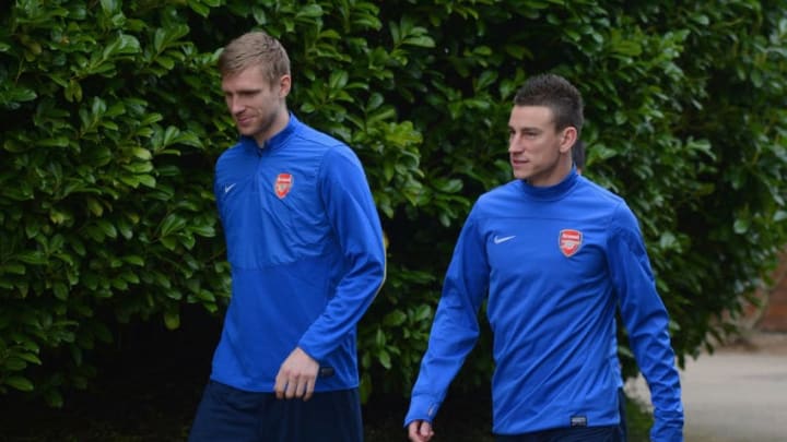 ST ALBANS, ENGLAND - MARCH 10: Per Mertesacker and Laurent Koscielny look on during the Arsenal training session at London Colney on March 10, 2014 in St Albans, England. (Photo by Michael Regan/Getty Images)