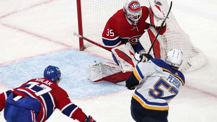 Feb 17, 2022; Montreal, Quebec, CAN; Montreal Canadiens Sam Montembeault makes a save against David Perron. Mandatory Credit: Jean-Yves Ahern-USA TODAY Sports