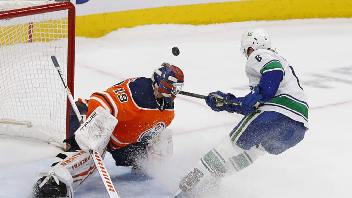 Apr 29, 2022; Edmonton, Alberta, CAN; Edmonton Oilers goaltender Mikko Koskinen (19) makes a save on a shot by Vancouver Canucks forward Brock Boeser (6) during the shoot-out at Rogers Place. Mandatory Credit: Perry Nelson-USA TODAY Sports