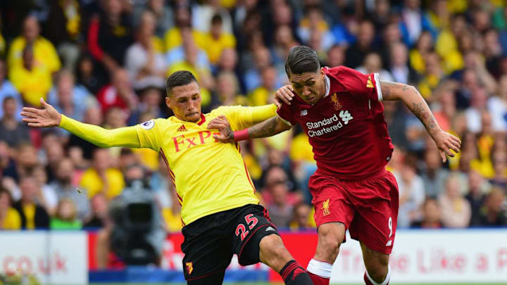 WATFORD, ENGLAND - AUGUST 12: Jose Hoebas of Watford tackles Roberto Firmino of Liverpool during the Premier League match between Watford and Liverpool at Vicarage Road on August 12, 2017 in Watford, England. (Photo by Tony Marshall/Getty Images)