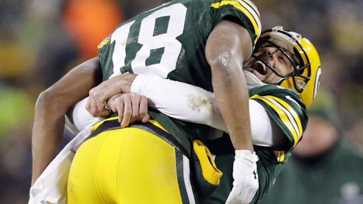 Jan 8, 2017; Green Bay, WI, USA; Green Bay Packers wide receiver Randall Cobb (18) celebrates with quarterback Aaron Rodgers (12) after scoring a touchdown on a hail mary in the 2nd quarter in the NFC Wild Card playoff football game at Lambeau Field. Mandatory Credit: Rick Wood/Milwaukee Journal Sentinel via USA TODAY Sports