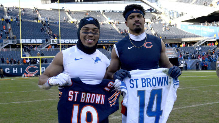 CHICAGO, ILLINOIS - NOVEMBER 13: Amon-Ra St. Brown #14 of the Detroit Lions and Equanimeous St. Brown #19 of the Chicago Bears pose with each others jerseys after Detroit's 31-30 win at Soldier Field on November 13, 2022 in Chicago, Illinois. (Photo by Quinn Harris/Getty Images)