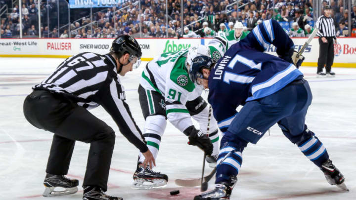 WINNIPEG, MB - JANUARY 6: Adam Lowry #17 of the Winnipeg Jets takes a first period face-off against Tyler Seguin #91 of the Dallas Stars at the Bell MTS Place on January 6, 2019 in Winnipeg, Manitoba, Canada. (Photo by Jonathan Kozub/NHLI via Getty Images)